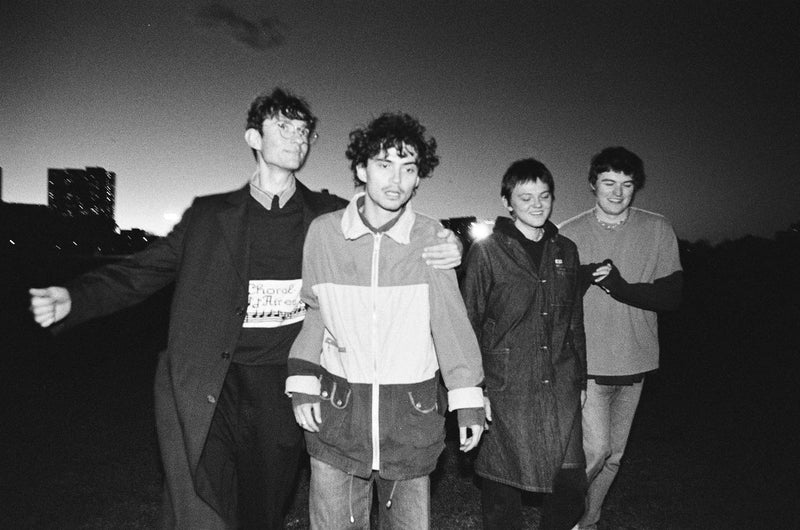 Black and white photo of the band outside